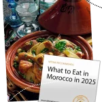 Colorful Moroccan dishes including tagine, couscous, and fresh spices on a traditional table.