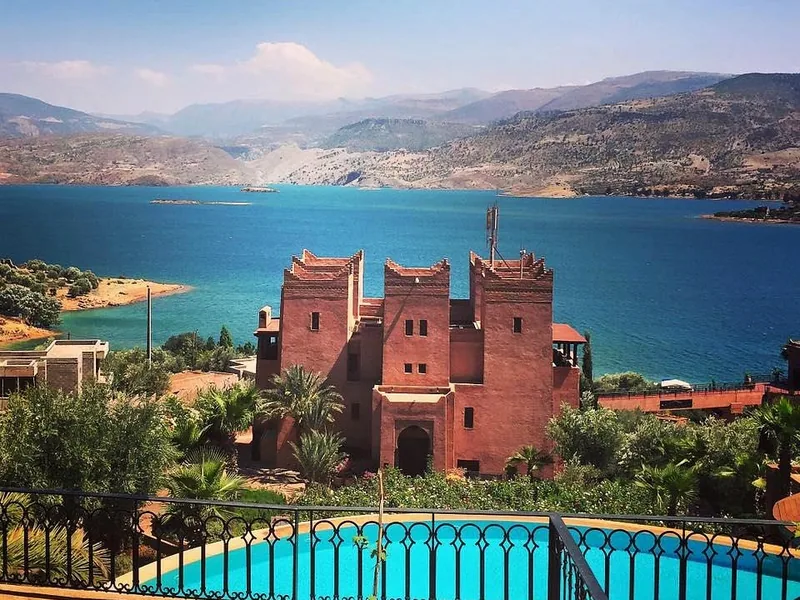 The reservoir of Bin El Ouidane held between red mountains in the central High Atlas