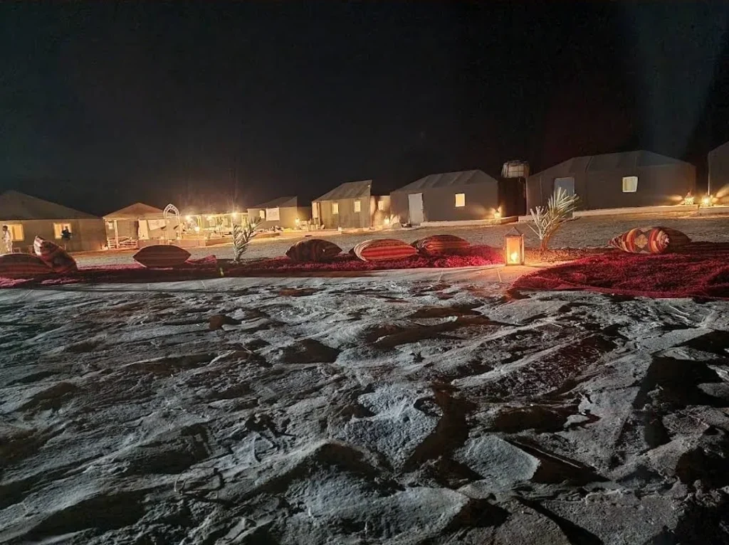 The Zagora luxury desert camp lit up at night