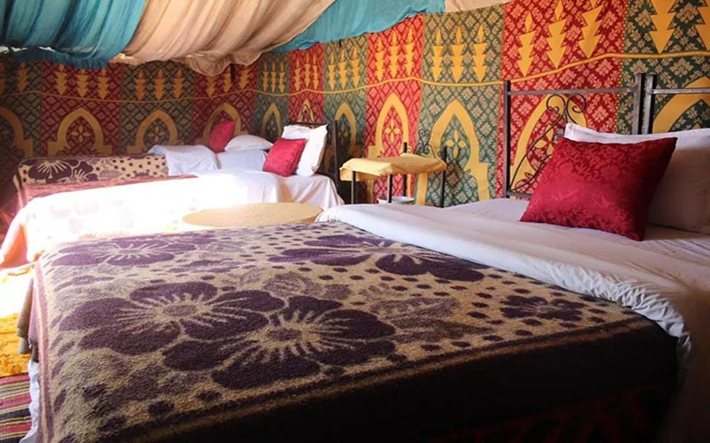 Standard Berber tent with three beds at the Zagora desert camp