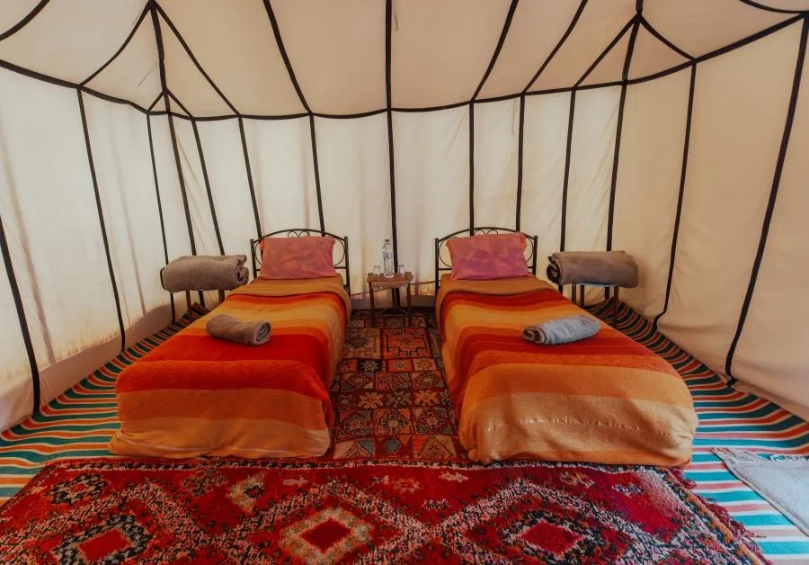 Standard Berber tent with two beds at the Zagora desert camp